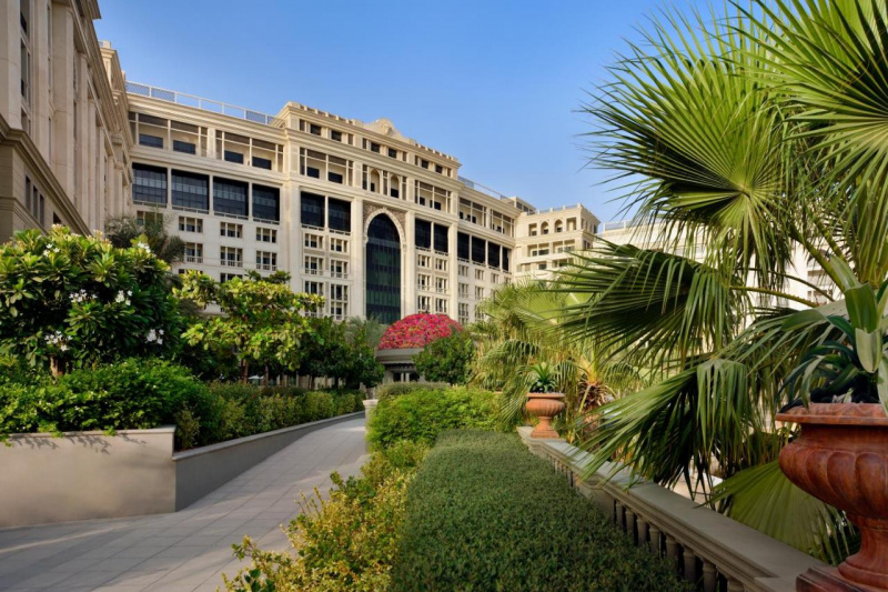 An external view of the hotel with a paved ramp leading to the hotel entrance.