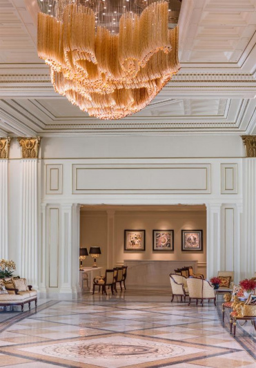 The spacious seating area has assorted tables and chairs to the sides of the room.