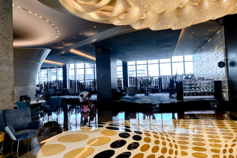 The spacious lobby has assorted tables and chairs. There is a small step up to one of the seating areas. There are no handrails