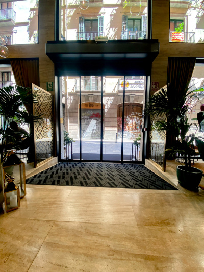 The hotel doors have a wide, carpeted ramp leading up to the lobby.
