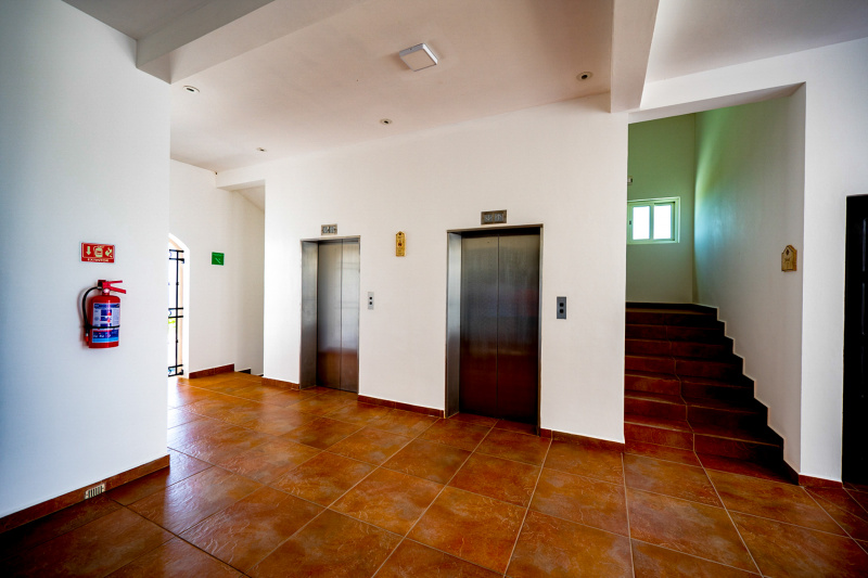 There are 2 elevators in a spacious and step-free area. Stairs on either side of the elevators lead to other floors. There are no handrails.