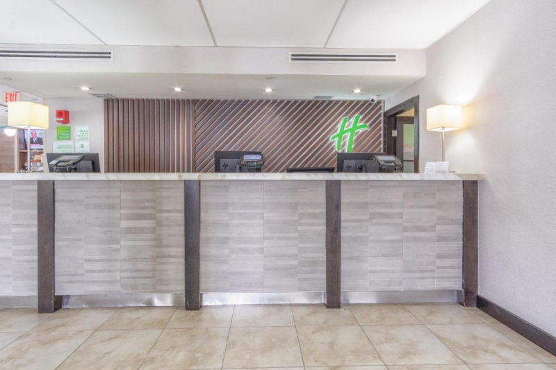 The spacious, step-free reception area has a long, high check-in desk with 3 monitors.