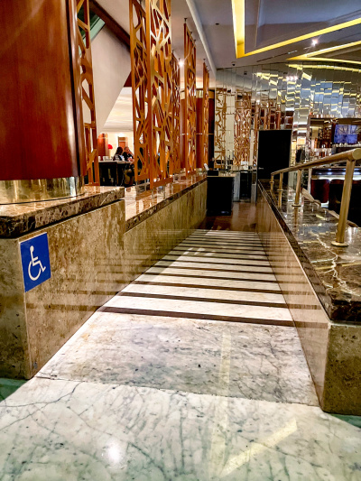 There is a marble ramp with anti-slip strips leading from one part of the hotel to another.