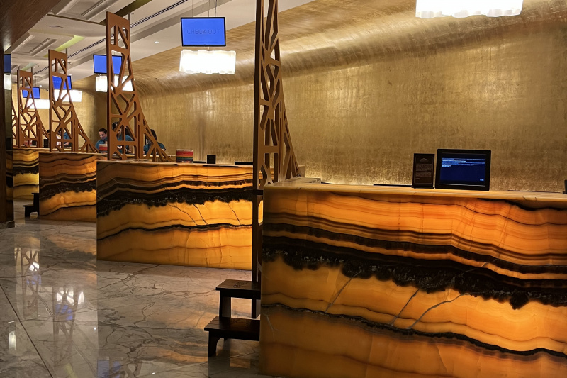 The reception area has a smooth marble floor with 4 reception desks with high counters. Two counters have 2-step ladders providing access to the desktops.