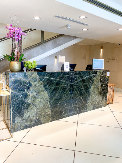 The check-in desk has a high counter but is in a spacious, step-free area.