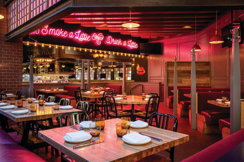 The spacious dining area has several booths and banquette seats around the room and 2 tables and movable chairs in the center.