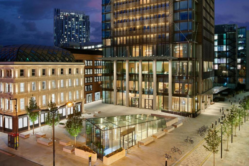 An exterior view of the hotel, sidewalk and street.