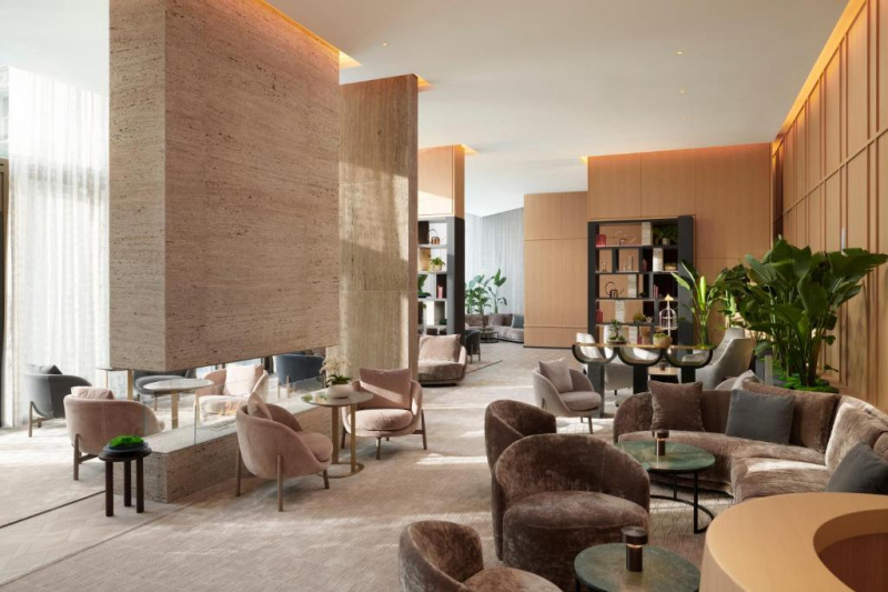 The spacious carpeted seating area has assorted coffee tables, plush sofas and movable plush tub chairs and armchairs.