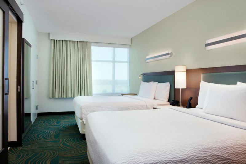 The room has 2 queen-sized beds with a central nightstand. There is also a built in closet.