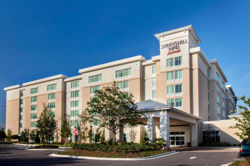 The hotel is a large, detached building. There is a wide driveway leading up to the entrance.
