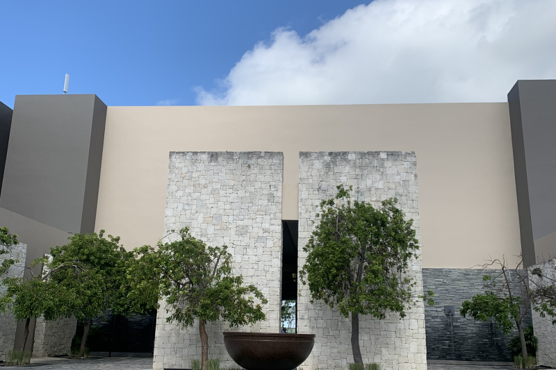 There is a cobbled courtyard, with small trees and a sculpture at one end.