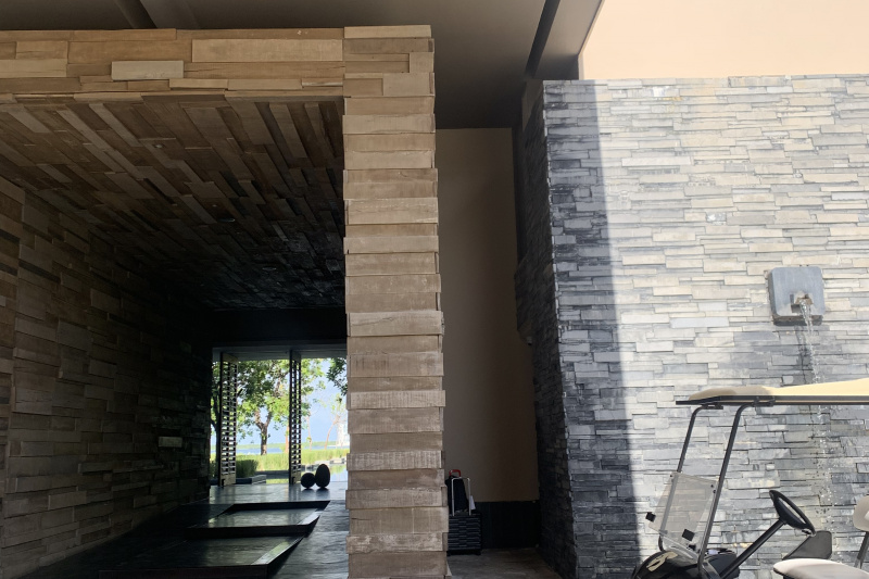 The paved area leads to a long corridor with a ramp slope.