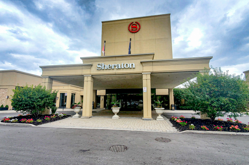 The hotel has a large covered driveway. There are automatic glass doors leading into the lobby.