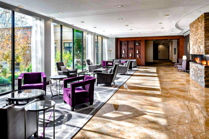 The seating area has seating on one side of the room and a long walkway on the other side. There is plenty of floor space.