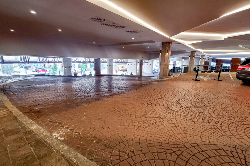 The hotel car park is covered, paved, and step-free. There are ramps leading up to each floor.
