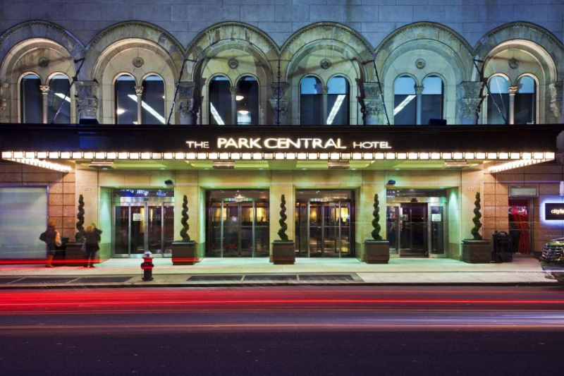 An external view of the hotel and covered main entrance from the sidewalk across the street.