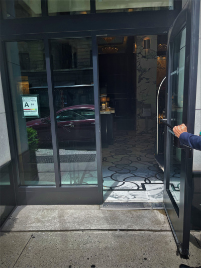 There is step-free access from the sidewalk to the hotel lobby through a secondary entrance with a manual push bar glass door.