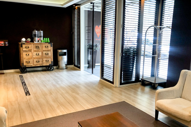 The hotel lobby is spacious and step-free. There is seating to one side of the room.