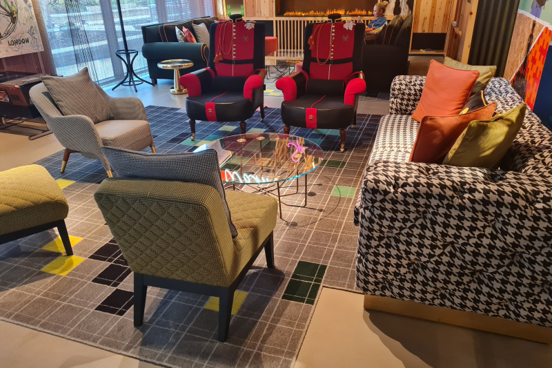 The seating area has assorted armchairs and sofas. There is adequate floor space.