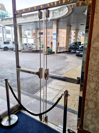 Two glass doors provide step-free access to the parking lot and a drop-off/set-down zone. There is a ramp for cars leading down to the main road.