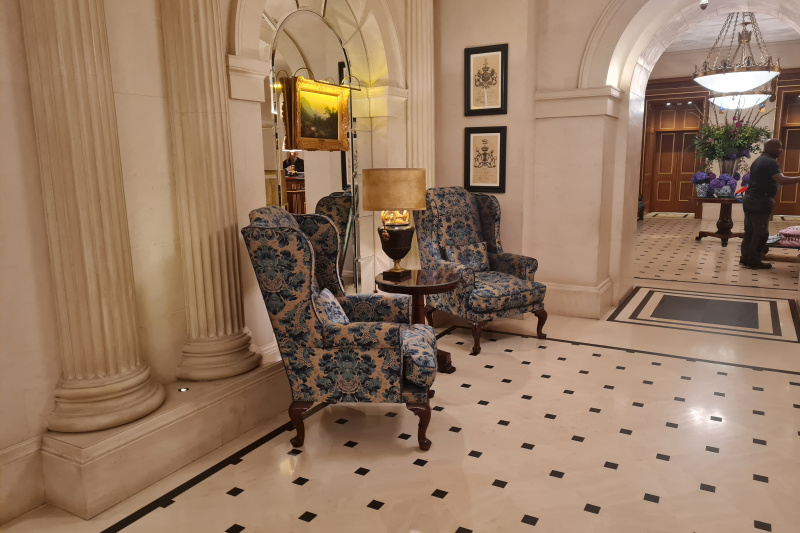 The lobby is spacious and step-free. There are 2 high-backed armchairs with a small coffee-table between them.
