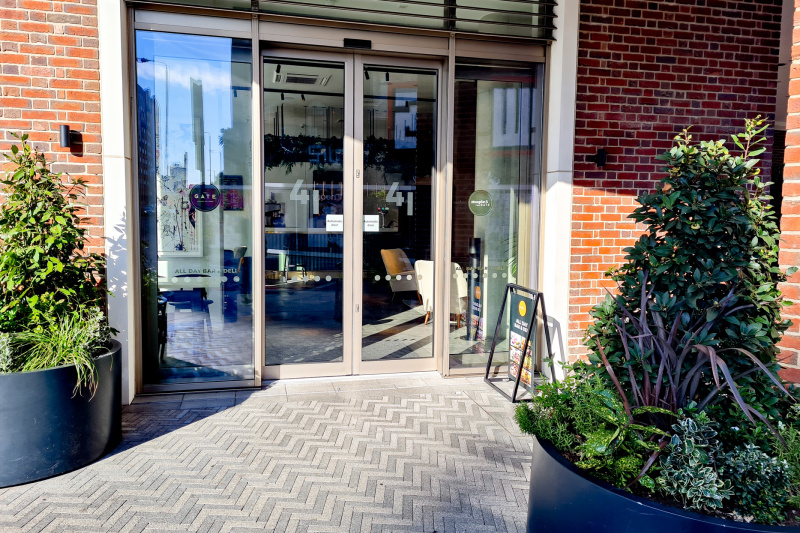 Access to the hotel is through 2 automatic glass doors from a paved step-free area.