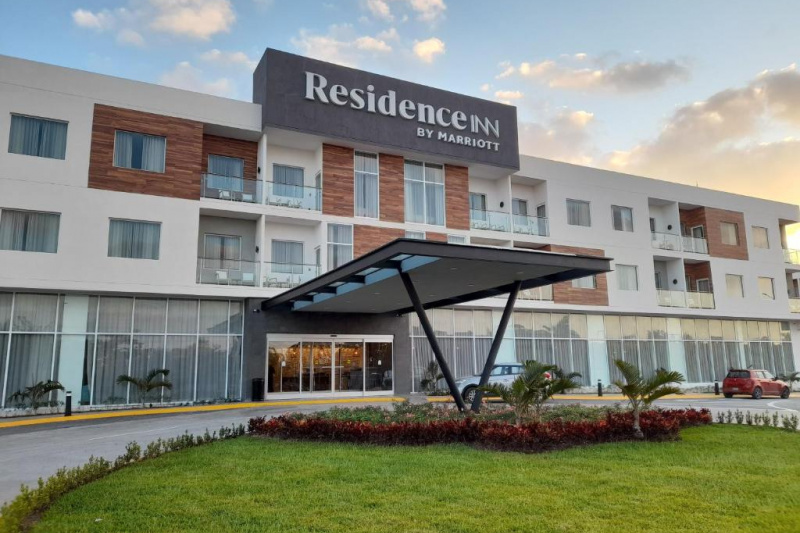 An external view of the hotel. There is a curved driveway leading up to the entrance.