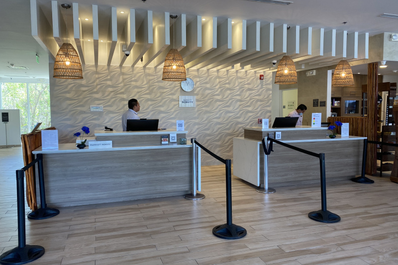 The spacious, step-free reception area has 2 high reception desks with rope queue barriers. The check-in desks have lowered counters.