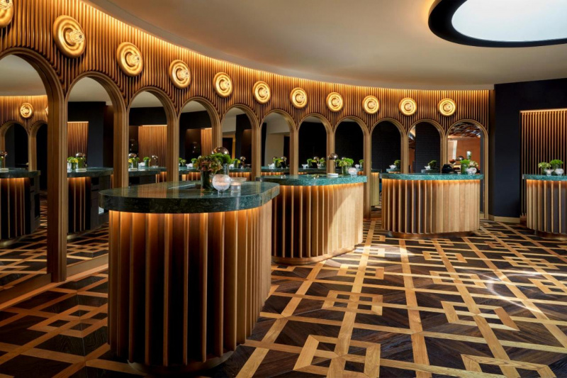 The spacious, elegant, hotel lobby has 4 marble-topped oval reception desks with high counters and a wall of mirrored archways.