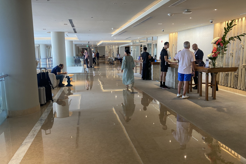 The spacious, step-free lobby has 2 check-in desks. There is a sofa in front of the check-in desk.