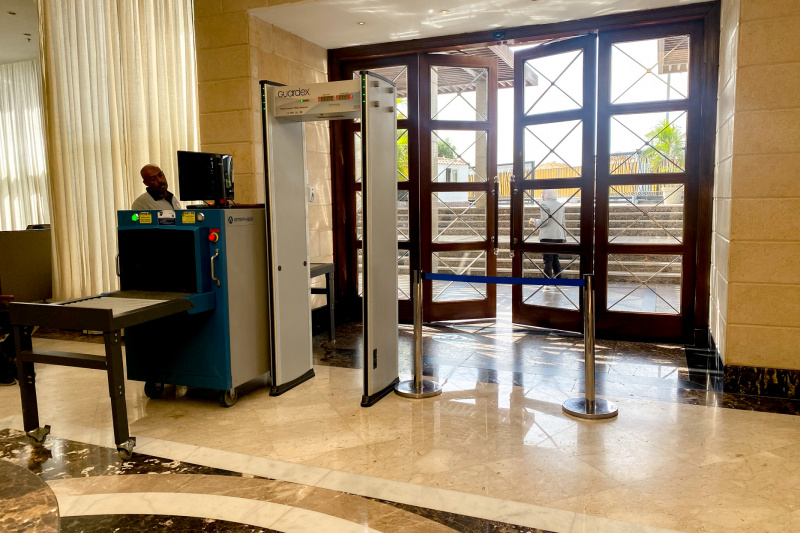 The hotel entrance has a walk-through metal detector, and baggage scanner. There are steps outside the hotel.