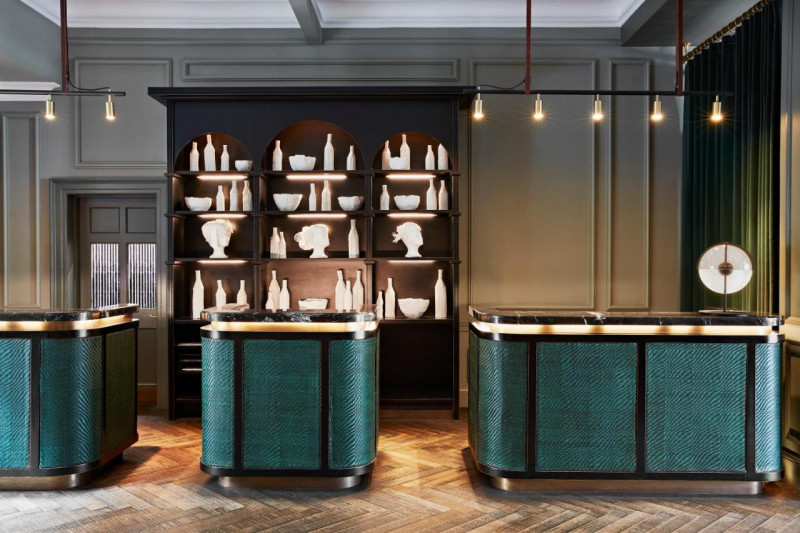The spacious reception area has 3 check-in desks with high counters. Behind the desk there is a wall unit with ornaments.