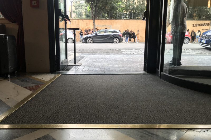 There is a large, open manual door, leading from the lobby to the sidewalk. The area is step-free.