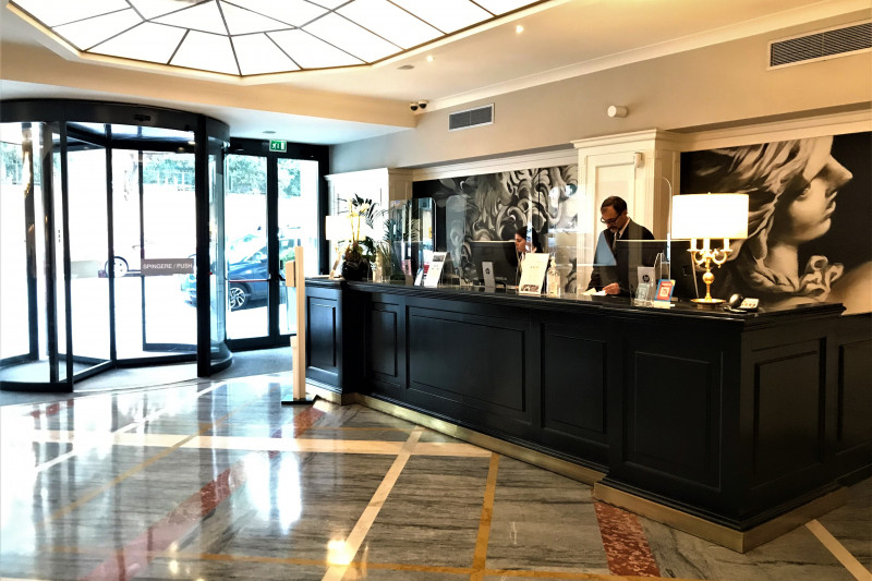 The spacious, step-free reception area has a high check-in desk with plexiglass protective screens.