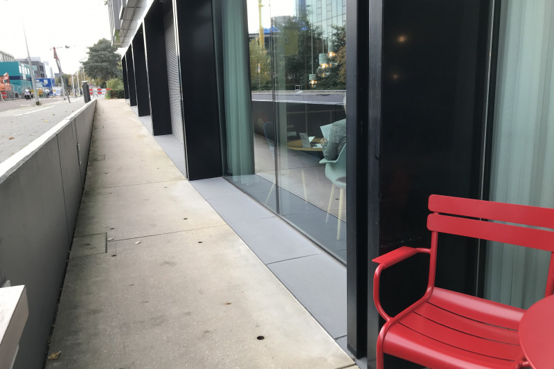 There is a ramp from the sidewalk, leading to the hotel entrance.