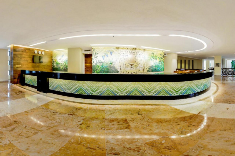 The spacious, step-free reception area has a high check-in desk. There is also a wall-mounted TV.