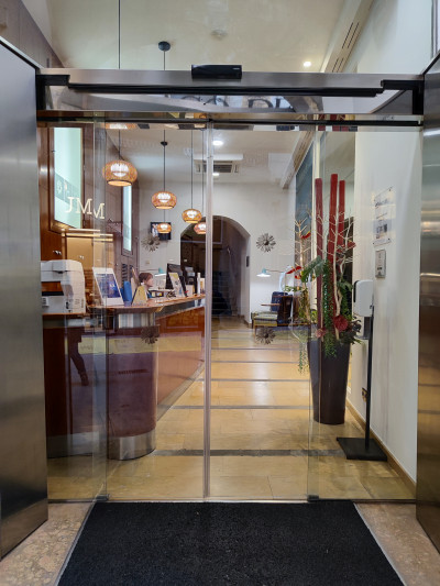 Access to the reception area is step-free and is through a sliding, glass door.