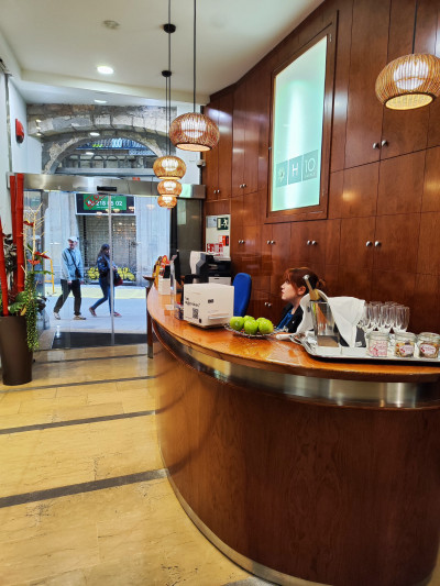 The hotel reception area leads out onto the sidewalk.