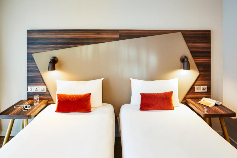 This room has twin beds, with built-in nightstands and plug sockets on either side.