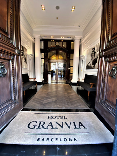 Access to to hotel is along a wide, step-free corridor with sofas on either side.