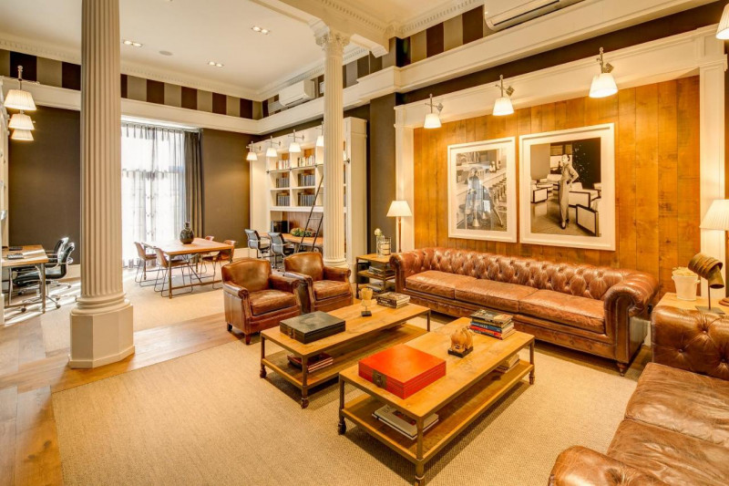 The spacious seating area has assorted tables, chairs, and sofas.