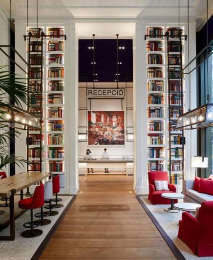The spacious, step-free reception area has assorted tables and chairs. There are 2 floor-to-ceiling bookcases.