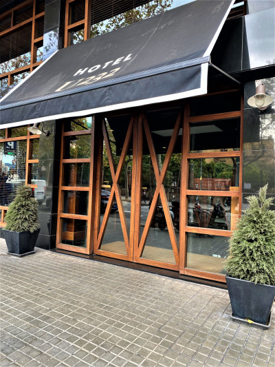 Access to the hotel is from a step-free cobbled sidewalk through 2 wooden and glass sliding doors.