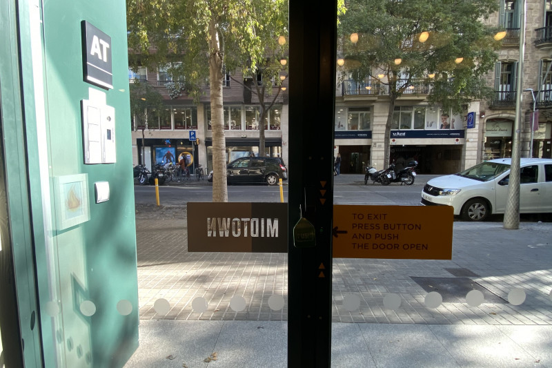 The hotel lobby leads out onto the sidewalk. There is a press button to open the door to the sidewalk.