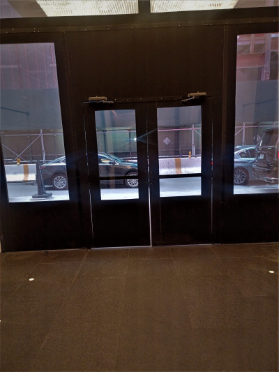There are 2 manual glass doors that lead onto the sidewalk.