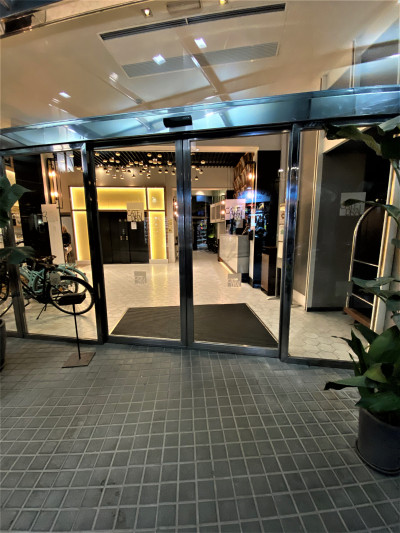 Access to the spacious reception area is from a cobbled area. The sliding glass doors open onto the check-in desk and 2 elevators with accessible call buttons.