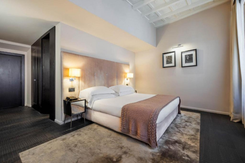 This very spacious room has a king-sized bed with nightstands on either side.