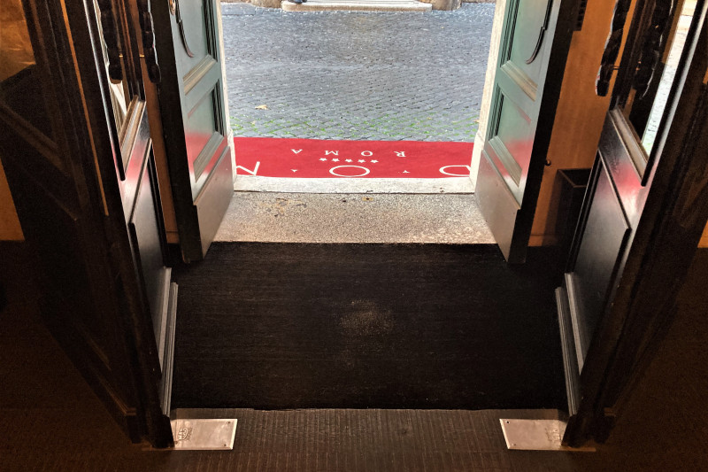 The entrance to the hotel is from the sidewalk. There is a small step up to the entrance.