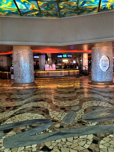 The lobby is spacious and step-free. There are 3 small steps with handrails leading to a bar. There are multiple TV screens.