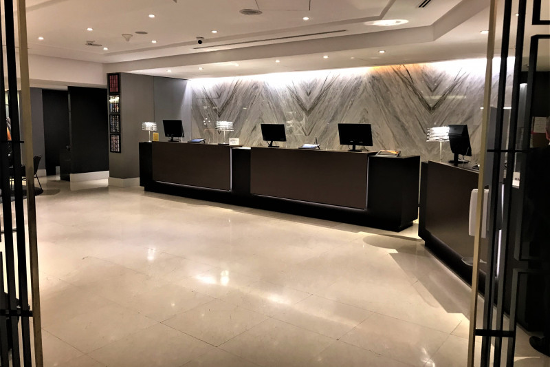 The spacious reception area has high-check-in desks with plexiglass screen protection.